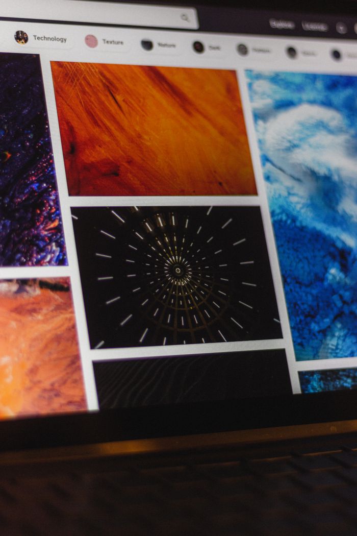 services-03 Portable computer with website representing assorted abstract photos under favorites and browser search engine with magnifier symbol
